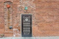 Decorative metal door on red brick building on overcast day in New Mexico Royalty Free Stock Photo