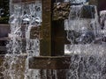 Decorative metal fountain with falling clear water Royalty Free Stock Photo