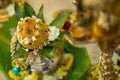 Decorative metal kalasha (metal pot) with green leaves and coconut - Indian wedding ceremony