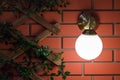 Decorative night round lantern lamp on a brick wall