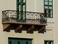 Decorative old stone balcony in low level view on multi level classic white building Royalty Free Stock Photo
