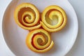 Decorative orange peels on white plate Royalty Free Stock Photo