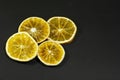 Decorative orange slices lie on a black matte surface. Still life on a black table Royalty Free Stock Photo