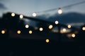 Decorative outdoor string lights at night time, Defocused Background, night city life backdrop, party time with Yellow Royalty Free Stock Photo