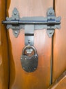 An decorative padlock in a wooden door