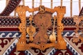 Decorative panel made of wood and leather with Kazakh folk musical instruments hangs on the felt wall of the yurt with traditional