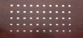 Decorative panel mahogany with perforated chrome squares design element