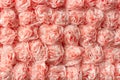 Decorative paper roses from napkins as texture background pattern. Creative festive wall decoration Royalty Free Stock Photo