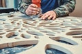 Decorative partition wall with floral pattern. Carpenter milling holes in MDF with a hand electric router machine Royalty Free Stock Photo