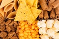 Decorative pattern of crunchy spicy snacks, top view, closeup. Fast food background.