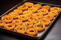 a decorative pattern made with onion rings on a tray