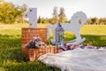 Decorative photozone for 1 year old boy birthday outdoors. Plaid, lantern, number one, basket with dry flowers, rocking horse