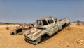 Old wrecks of rusty cars decorate the Solitaire station in Namibia Royalty Free Stock Photo