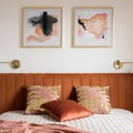 Decorative pillows on bed with velvet headboard, close-up Royalty Free Stock Photo