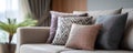 Decorative pillows with various textures and patterns arranged modern beige sofa creating cozy and stylish living room Royalty Free Stock Photo