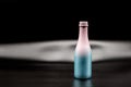 Decorative pink-blue glass wine bottle on a black background Royalty Free Stock Photo
