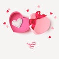 Decorative pink gift box with red bow, white felt heart and heart confetti isolated on white background. Royalty Free Stock Photo