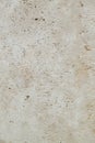 Decorative plaster of beige color with small holes, wall surface.