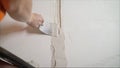 Decorative plaster coating. Man does ragged texture on the wall using a spatula. plaster application on the wall Royalty Free Stock Photo