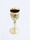 Decorative plastic glass made in the form of a gilded cup for the utterance of Jewish prayers isolated on a white background Royalty Free Stock Photo