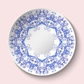 Decorative plate with blue floral ornament in a circle. Empty space in the center. The ethnic style of painting on porcelain Royalty Free Stock Photo