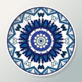 Decorative plate with mandala in ethnic style. Oriental round ornament in blue colors