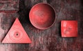 Decorative Plates Of Various Shapes On Old Grunge Textured Wall. Abstract Living Coral Color Toned Vintage Background