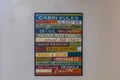 A decorative poster with guest rules on a white cabin wall with many friendly words