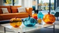 Decorative pumpkins of different sizes and shapes made of colored glass. Stylish Halloween decor. White blurred living