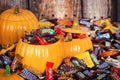 Decorative pumpkins filled with assorted Halloween chocolate can