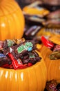 Decorative pumpkins filled with assorted Halloween chocolate can