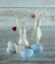 Decorative rabbits and Easter eggs on a wooden background Royalty Free Stock Photo