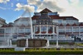 Decorative red and white colored building with fountain and small pool in foreground. Sopot - Baltic region, Poland.