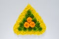 Decorative rangoli made from colorful marigold flowers and petals with green Chrysanthemum for Diwali festival