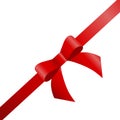 Decorative red bow with diagonally ribbon on the corner.