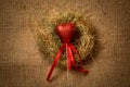 Decorative red heart on stick with ribbon in nest Royalty Free Stock Photo