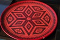 Decorative red Oriental , turkish, Azerbaijani dish with an Asian pattern on black background Royalty Free Stock Photo