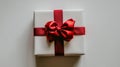 Decorative red ribbon with bow on a white gift box Royalty Free Stock Photo