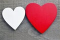 Decorative red and white wooden hearts on a grey wooden background.Two Valentine hearts.Saint Valentine`s Day or Love concept. Royalty Free Stock Photo