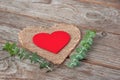 Decorative red wooden heart on on a burlap napkin in the shape o Royalty Free Stock Photo