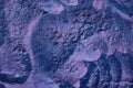 Decorative relief plaster. Dark deep blue and violet painted relief wall with rough chaotic convex elements. Royalty Free Stock Photo