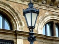 Decorative retro style gray street lamp detail with light yellow beige brick classical facade Royalty Free Stock Photo