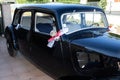 Decorative ribbon hanging on vintage door of ancient bride black car at wedding day Royalty Free Stock Photo