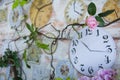 Decorative rose against the background wall clock in the interior of the room Royalty Free Stock Photo