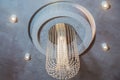 Decorative round chandelier in dining room at home .Interior design electrical lamps hanging on the ceiling.Luxury lighting Royalty Free Stock Photo