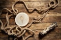 Decorative round log of wood on a table made of aged boards, rope rope made of jute, logs Royalty Free Stock Photo