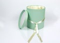 Decorative Round Teal Hat Box with Cream colored ribbon isolated