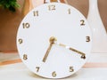 Decorative round white table clock with golden numbers and arrows