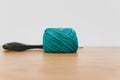 decorative rustic cyan yarn ball and scissors on a wooden tabletop