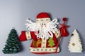 Decorative Santa Claus doll and Christmas tree on a gray background with space to copy Royalty Free Stock Photo